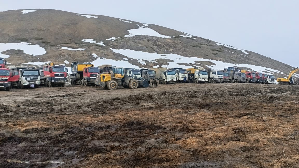 Техника и грузовики на площадке месторождения в период распутицы